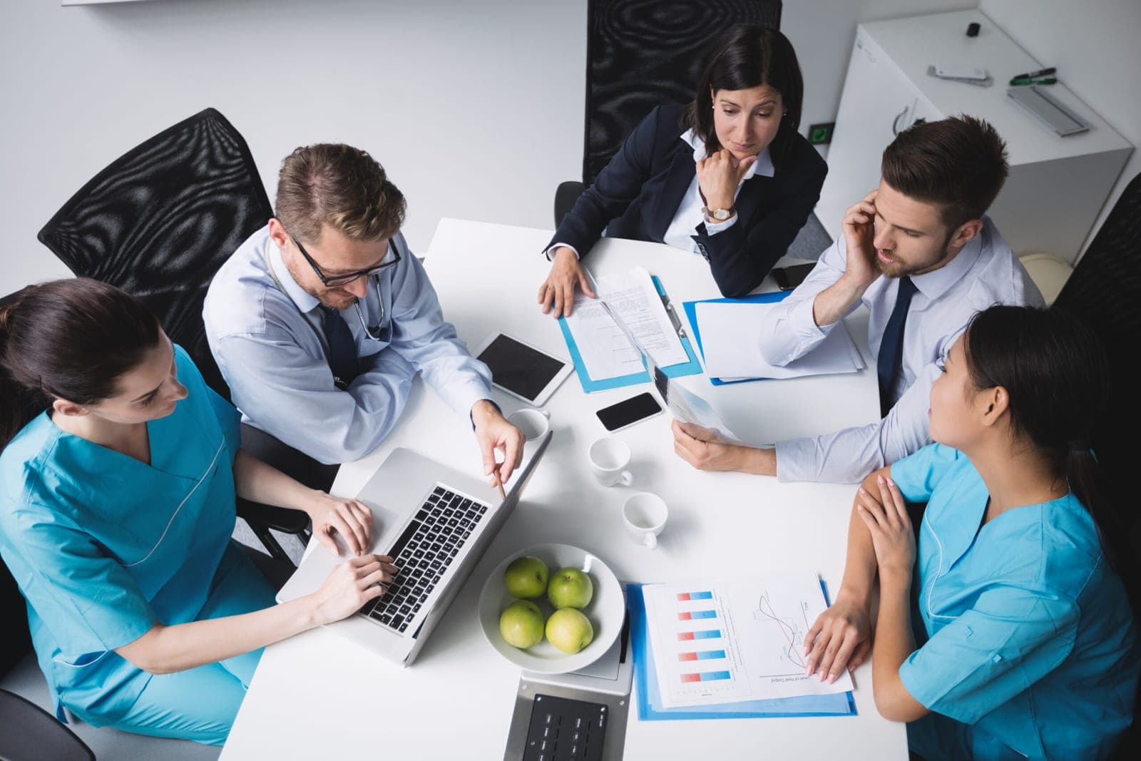 A team of adults meeting around a table to plan