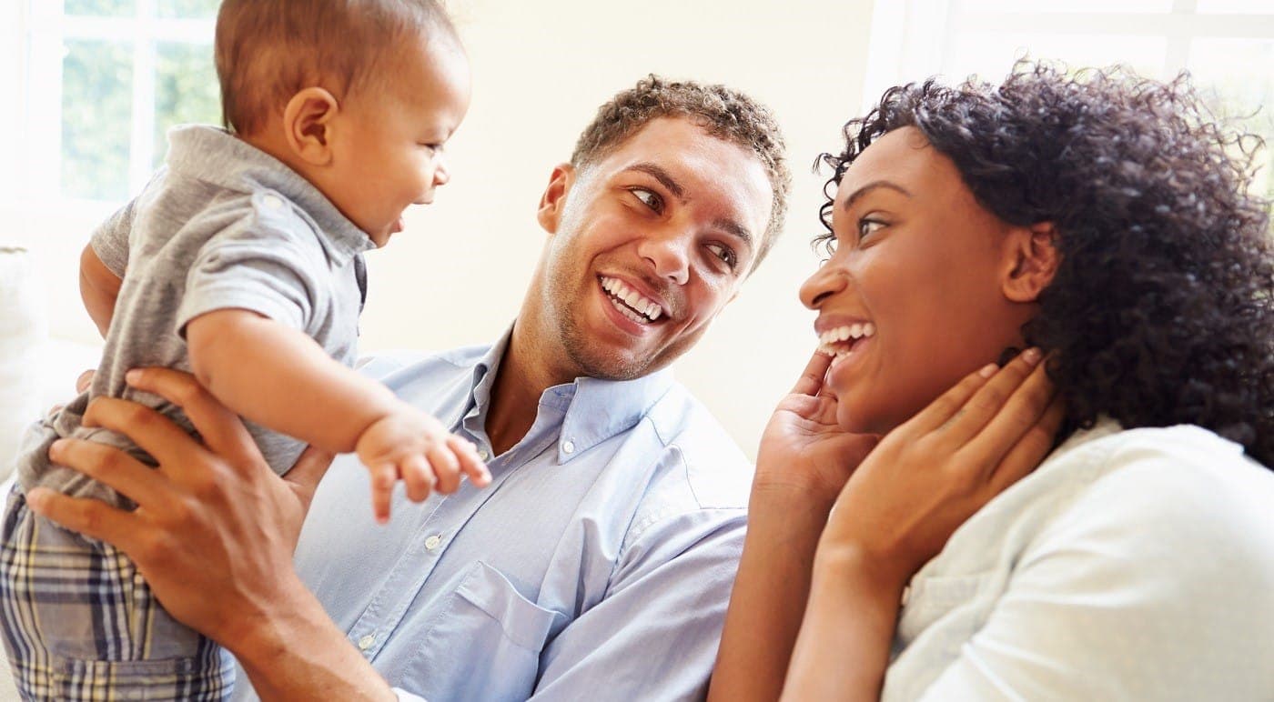 Parents laughing with their baby