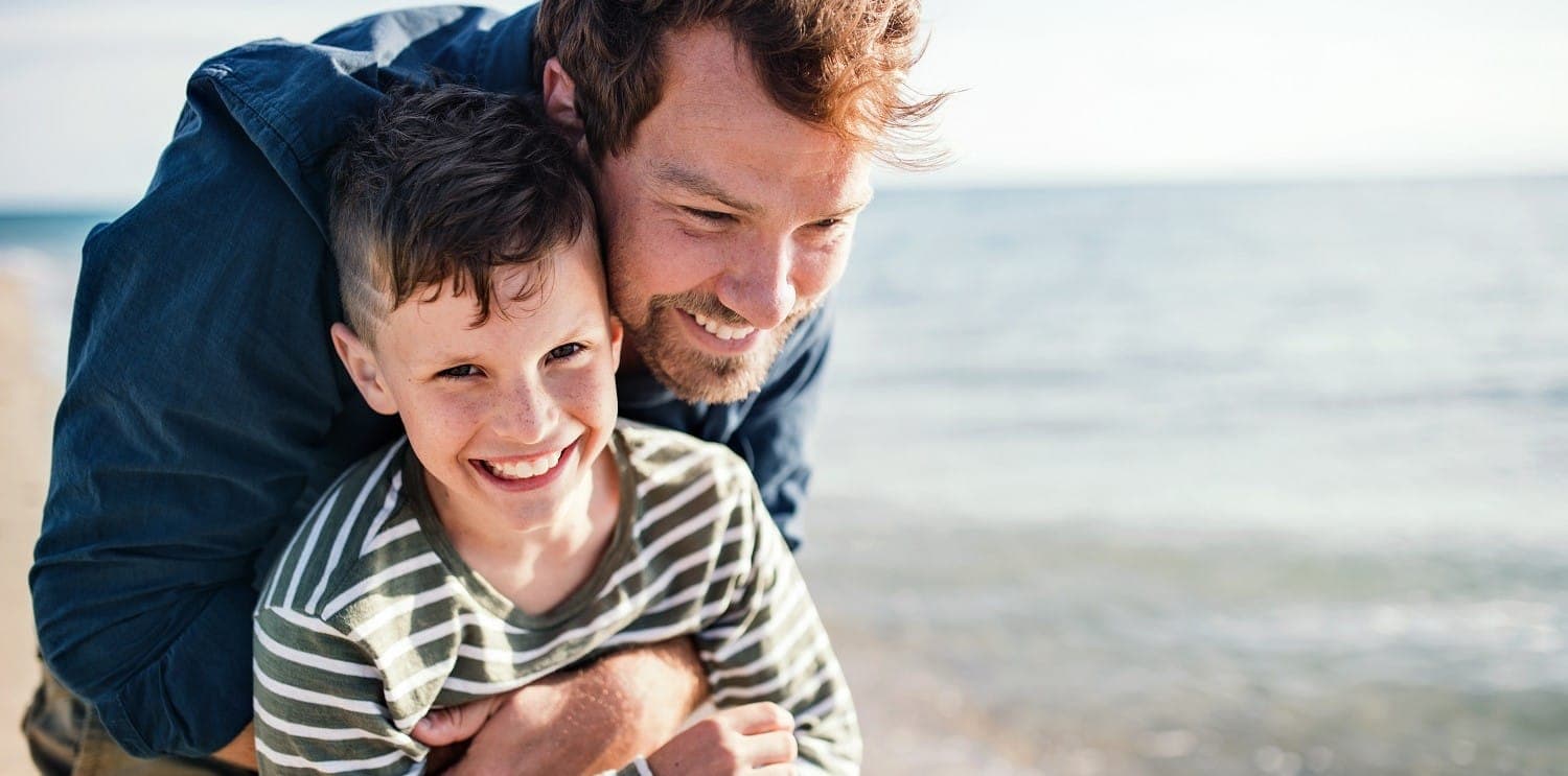 A father and his young son spending time together at the beach