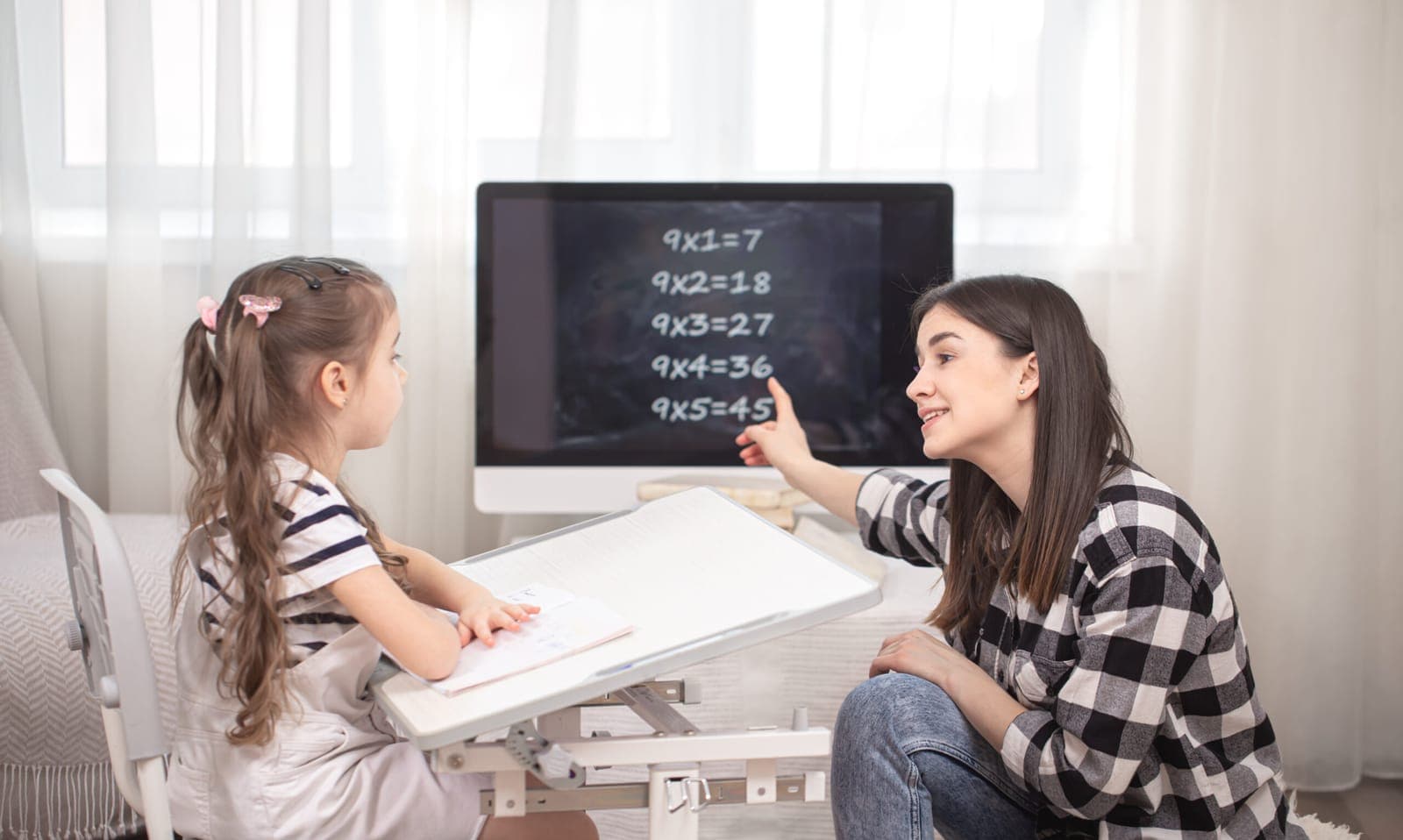 A parent and child sitting together at the kitchen table