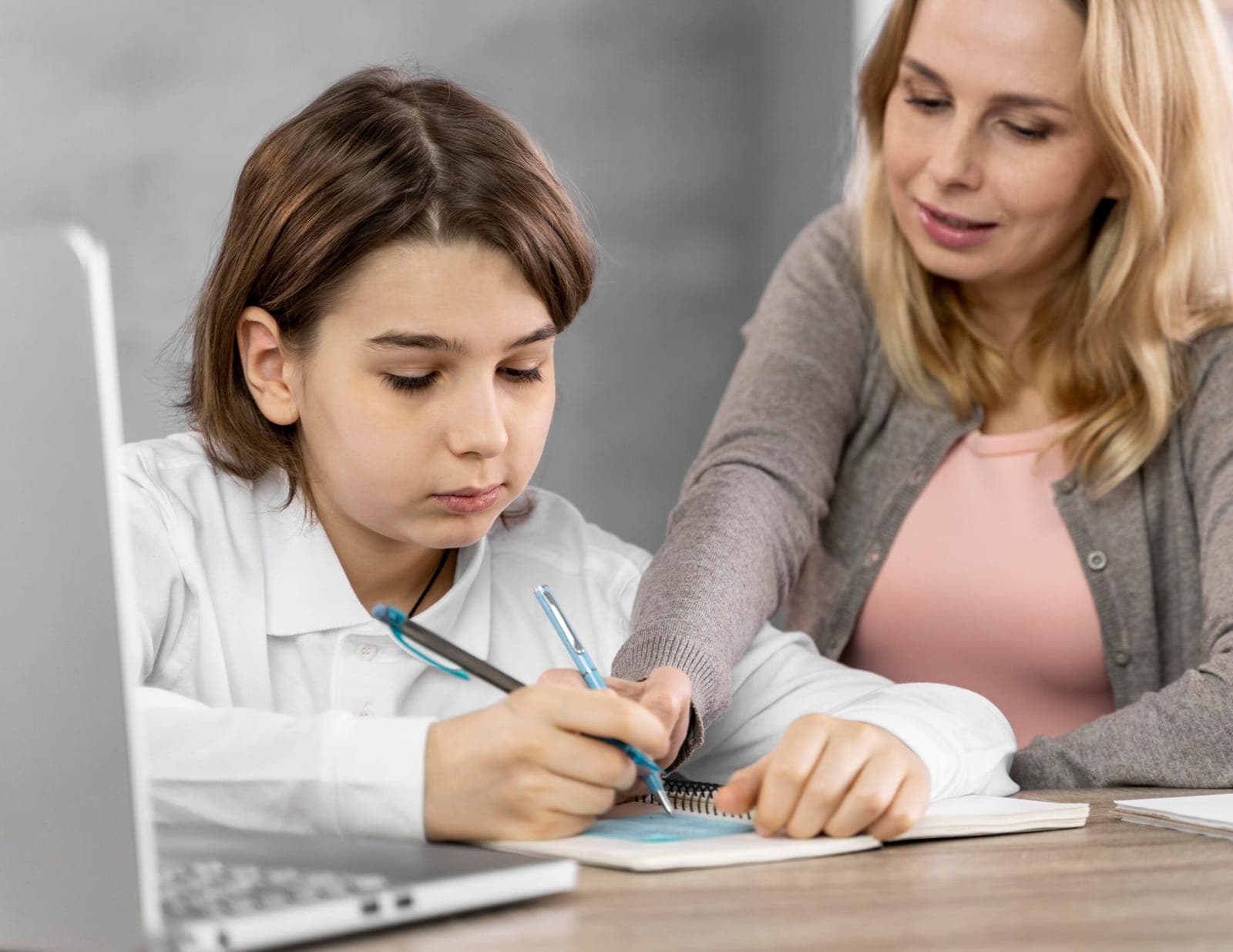 A parent helping a child with schoolwork at home