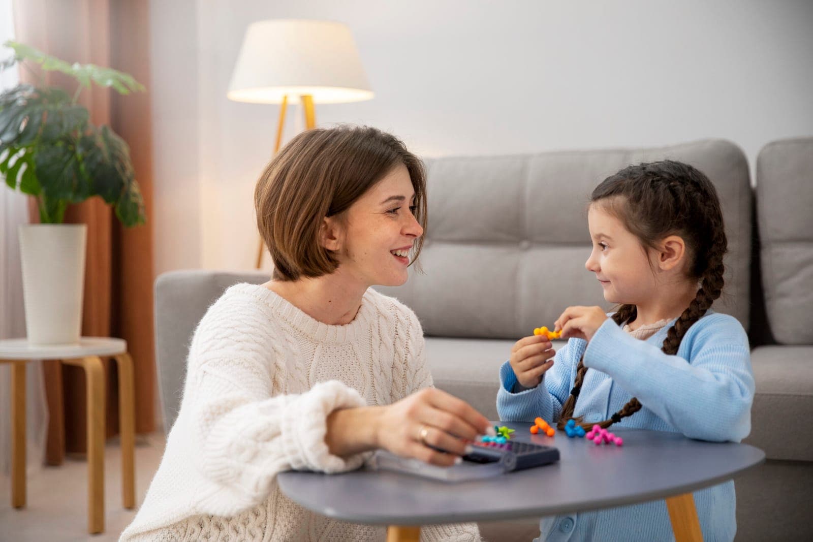 A young girl and her mother playing a matching card game