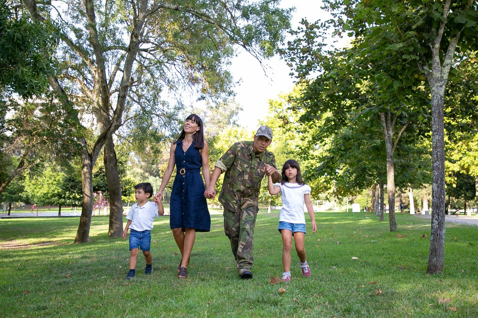A military family walking together in a park