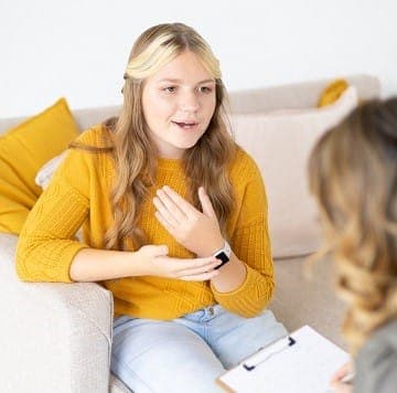 A teenager talking with a therapist