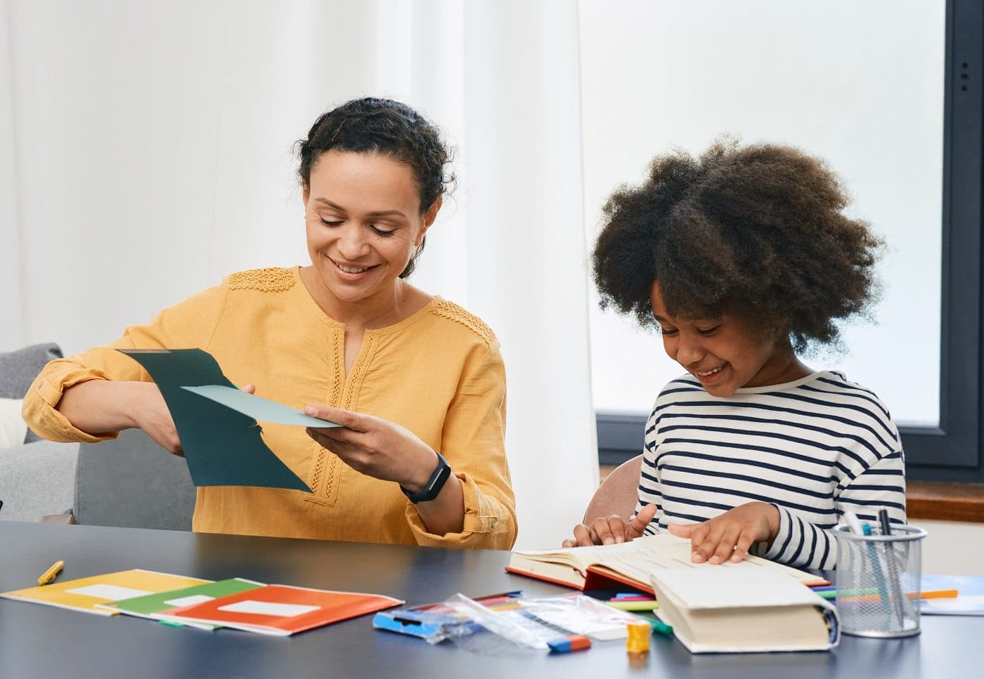 A therapist and a young girl working with colored cards at a table