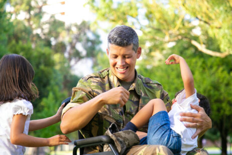Cheerful disabled military dad enjoying leisure time with kids